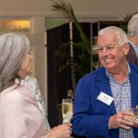 Greg Willit chatting with other event guest